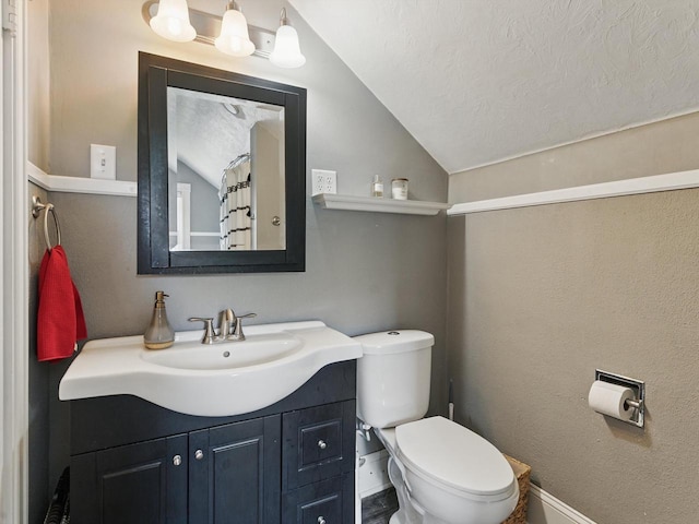 409 Huron St, Manitowoc, WI 54220 - full bath featuring vaulted ceiling, vanity, toilet, a textured ceiling, and baseboards