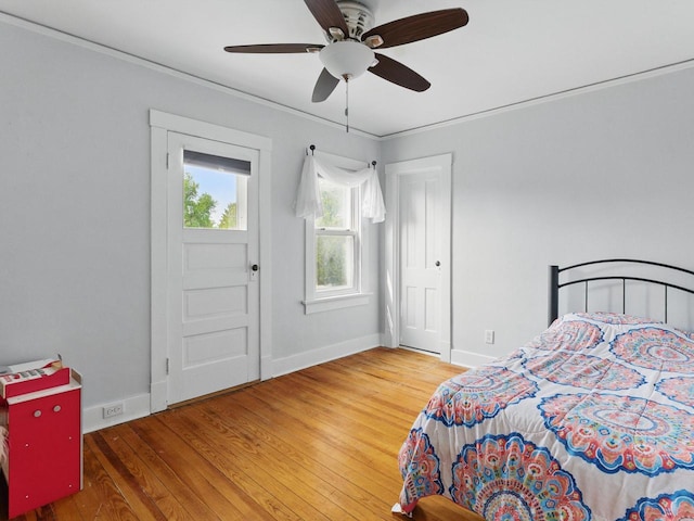 409 Huron St, Manitowoc, WI 54220 - bedroom featuring baseboards, wood finished floors, crown molding, and a ceiling fan