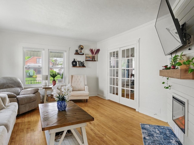409 Huron St, Manitowoc, WI 54220 - living area with light wood-type flooring, crown molding, a glass covered fireplace, and baseboards