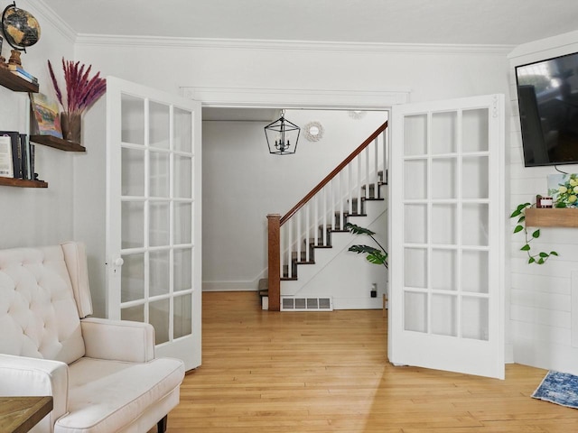 409 Huron St, Manitowoc, WI 54220 - sitting room with ornamental molding, stairway, and wood finished floors