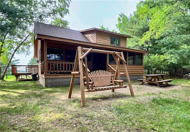 24730 Scenic View Ln, Spooner, WI 54801 - back of property with roof with shingles, a yard, and a wooden deck
