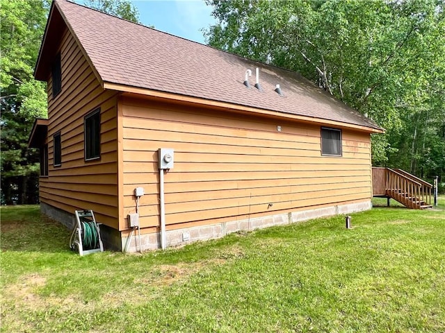 24730 Scenic View Ln, Spooner, WI 54801 - view of property exterior with a yard, a shingled roof, and stairs