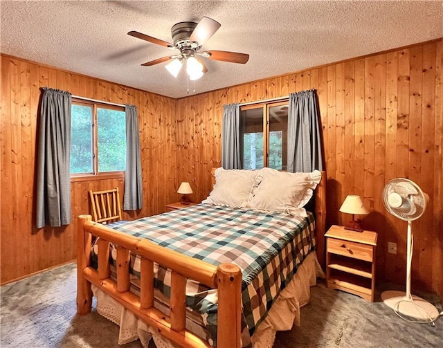 24730 Scenic View Ln, Spooner, WI 54801 - carpeted bedroom with wooden walls, a textured ceiling, and a ceiling fan