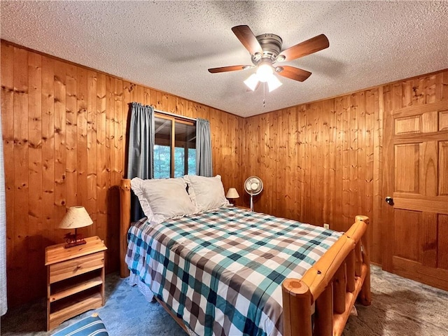 24730 Scenic View Ln, Spooner, WI 54801 - bedroom with carpet flooring, wood walls, a textured ceiling, and a ceiling fan