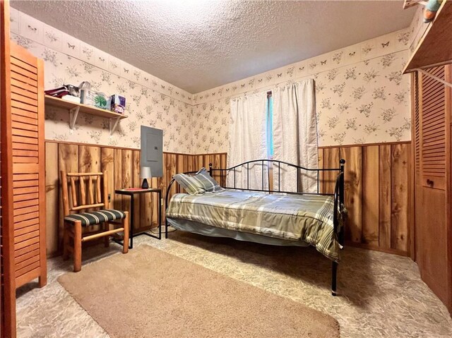 24730 Scenic View Ln, Spooner, WI 54801 - bedroom with a wainscoted wall, a textured ceiling, wallpapered walls, carpet, and wooden walls