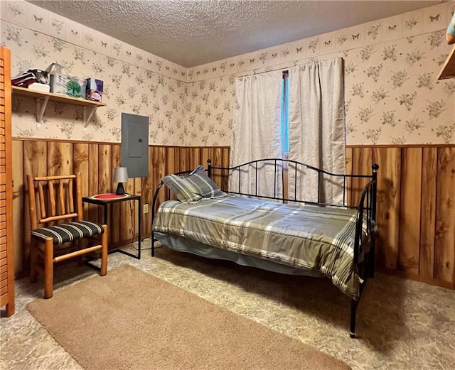 24730 Scenic View Ln, Spooner, WI 54801 - bedroom with a wainscoted wall, wallpapered walls, electric panel, a textured ceiling, and wood walls