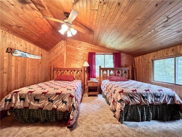 24730 Scenic View Ln, Spooner, WI 54801 - carpeted bedroom featuring lofted ceiling, multiple windows, wooden walls, and ceiling fan