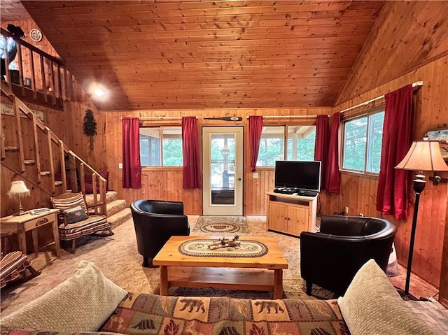 24730 Scenic View Ln, Spooner, WI 54801 - living room with lofted ceiling, wooden walls, stairs, healthy amount of natural light, and carpet flooring