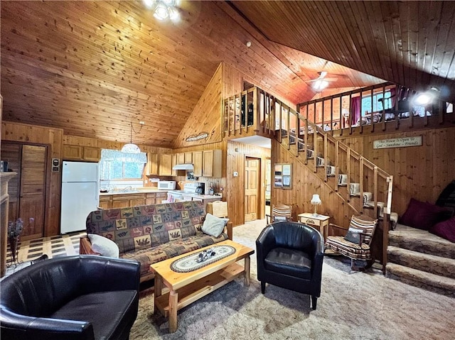 24730 Scenic View Ln, Spooner, WI 54801 - living area featuring wooden walls, wooden ceiling, light colored carpet, high vaulted ceiling, and stairway