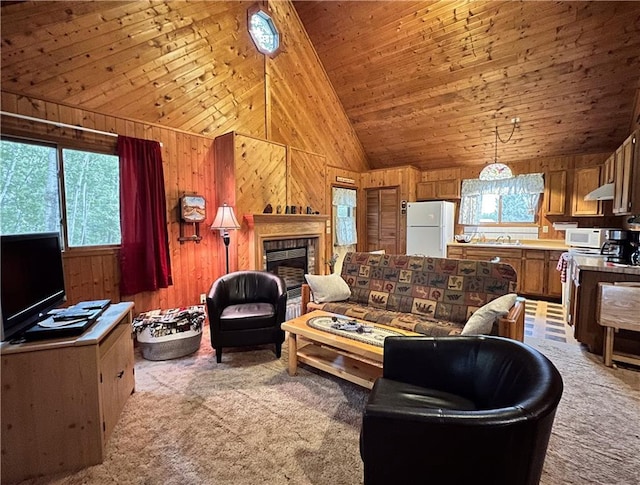 24730 Scenic View Ln, Spooner, WI 54801 - living room featuring carpet, plenty of natural light, wood walls, vaulted ceiling, and a tiled fireplace