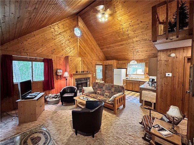 24730 Scenic View Ln, Spooner, WI 54801 - living room featuring wooden walls, wood ceiling, light colored carpet, a fireplace, and high vaulted ceiling