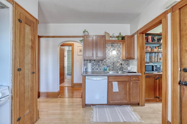 2116 N 60th St Unit 2118, Milwaukee, WI 53208 - kitchen with white dishwasher, a sink, arched walkways, and light wood-type flooring