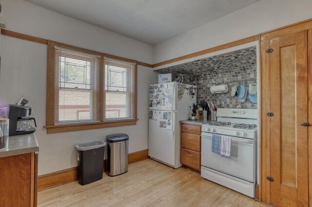 2116 N 60th St Unit 2118, Milwaukee, WI 53208 - kitchen with white appliances, light wood-style floors, brown cabinets, backsplash, and light countertops