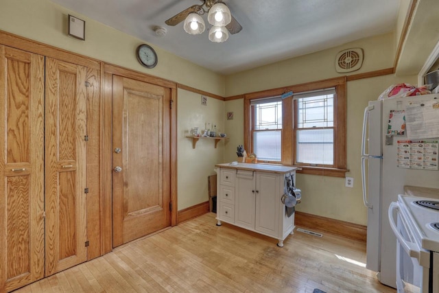 2116 N 60th St Unit 2118, Milwaukee, WI 53208 - kitchen featuring white appliances, a ceiling fan, light wood finished floors, and light countertops