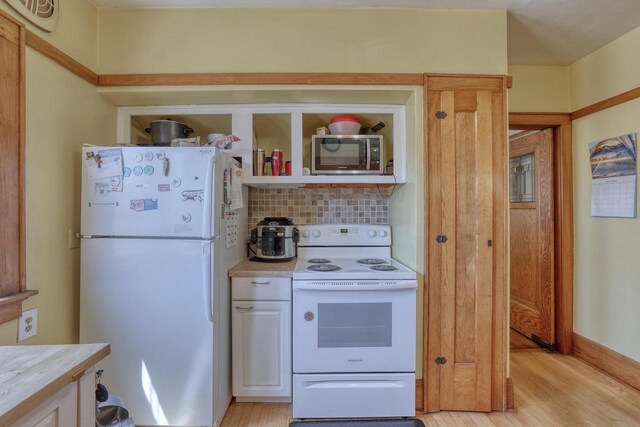 2116 N 60th St Unit 2118, Milwaukee, WI 53208 - kitchen featuring white appliances, light wood finished floors, backsplash, and light countertops