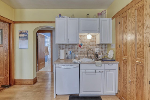 2116 N 60th St Unit 2118, Milwaukee, WI 53208 - kitchen featuring dishwasher, a sink, arched walkways, backsplash, and light countertops