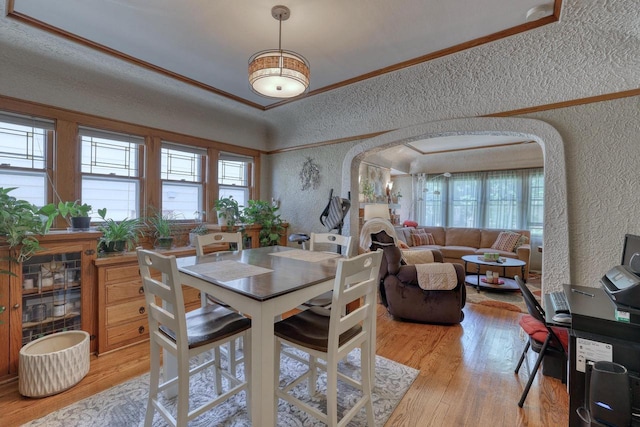 2116 N 60th St Unit 2118, Milwaukee, WI 53208 - dining room with a textured wall, arched walkways, plenty of natural light, light wood-type flooring, and ornamental molding