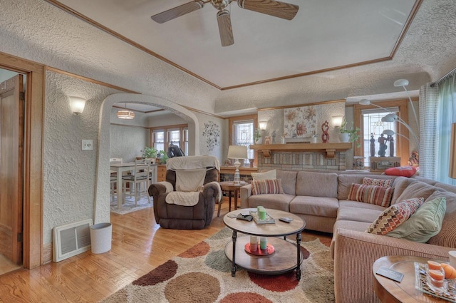 2116 N 60th St Unit 2118, Milwaukee, WI 53208 - living room featuring a textured wall, arched walkways, wood finished floors, healthy amount of natural light, and a ceiling fan