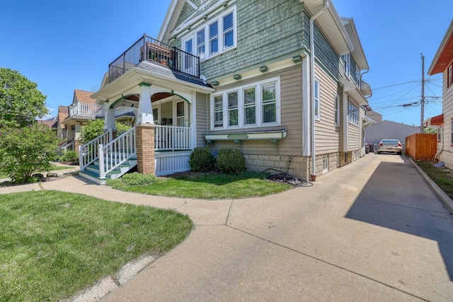 2116 N 60th St Unit 2118, Milwaukee, WI 53208 - view of front of house with a balcony, covered porch, and a front yard