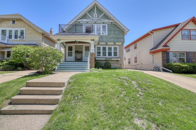 2116 N 60th St Unit 2118, Milwaukee, WI 53208 - view of front of property with a balcony, a front lawn, and covered porch