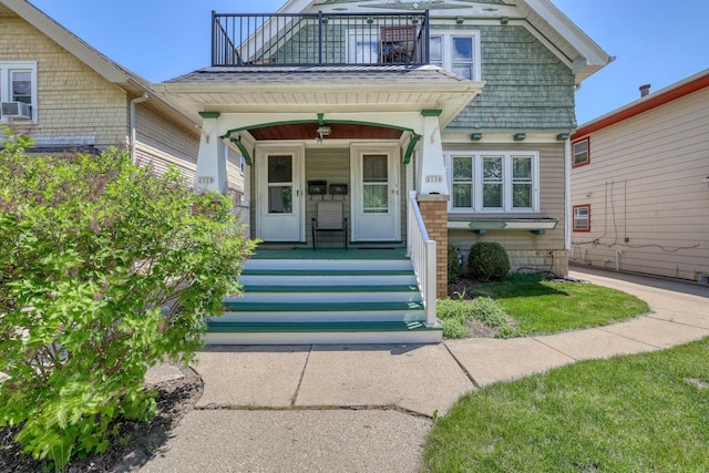 2116 N 60th St Unit 2118, Milwaukee, WI 53208 - doorway to property featuring a balcony, covered porch, and cooling unit