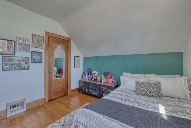 2116 N 60th St Unit 2118, Milwaukee, WI 53208 - bedroom featuring lofted ceiling, wood finished floors, and baseboards