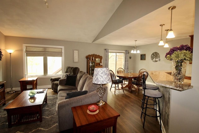 2253 Walnut St, Beloit, WI 53511 - living room featuring dark wood-style floors, a chandelier, and baseboards
