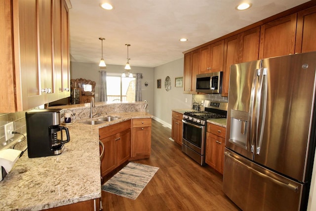 2253 Walnut St, Beloit, WI 53511 - kitchen with appliances with stainless steel finishes, brown cabinetry, dark wood-type flooring, a sink, and recessed lighting