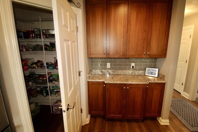2253 Walnut St, Beloit, WI 53511 - bar featuring dark wood-style floors, backsplash, and baseboards