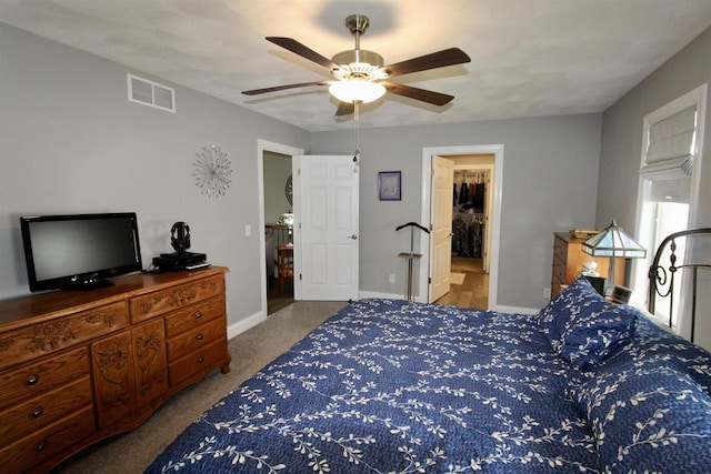 2253 Walnut St, Beloit, WI 53511 - bedroom featuring carpet, a walk in closet, a ceiling fan, and baseboards