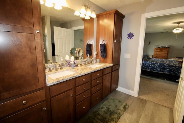 2253 Walnut St, Beloit, WI 53511 - full bathroom featuring double vanity, connected bathroom, ceiling fan, baseboards, and wood finished floors