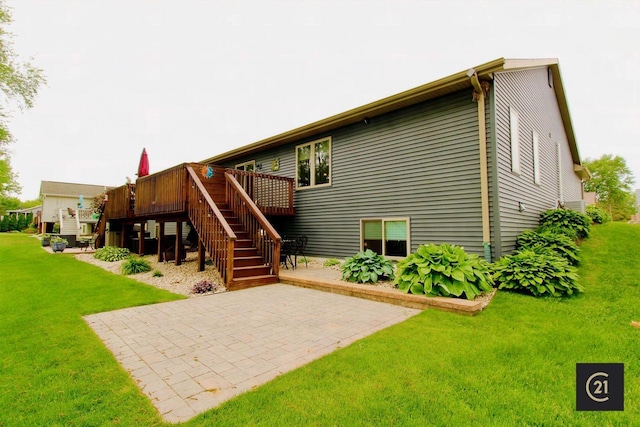 2253 Walnut St, Beloit, WI 53511 - back of house featuring stairs, a patio, a wooden deck, and a lawn