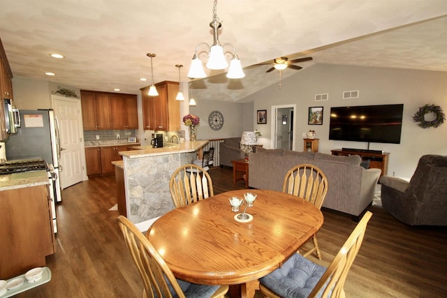 2253 Walnut St, Beloit, WI 53511 - dining area with dark wood-style flooring, vaulted ceiling, and a ceiling fan