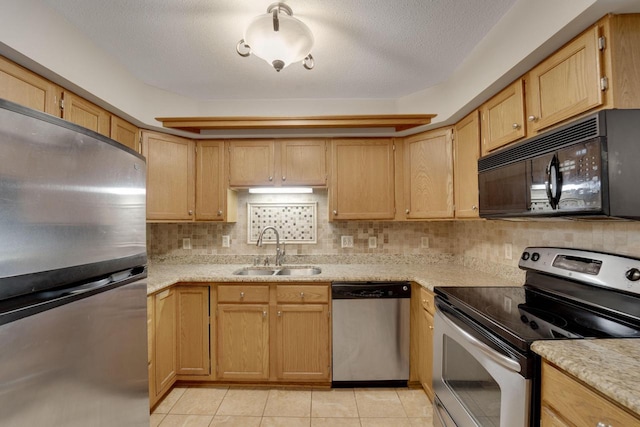 10380 W Whitnall Edge Cir Unit F, Franklin, WI 53132 - kitchen featuring appliances with stainless steel finishes, a sink, light tile patterned floors, and decorative backsplash
