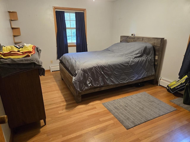 4817 Morgan Dr, Manitowoc, WI 54220 - bedroom with light wood-style flooring and baseboard heating