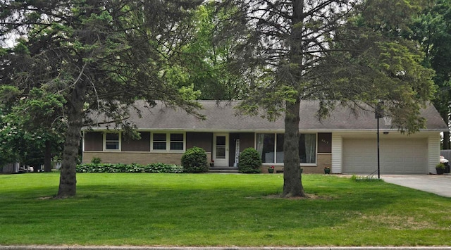 4817 Morgan Dr, Manitowoc, WI 54220 - view of front facade with an attached garage, a front lawn, driveway, and brick siding