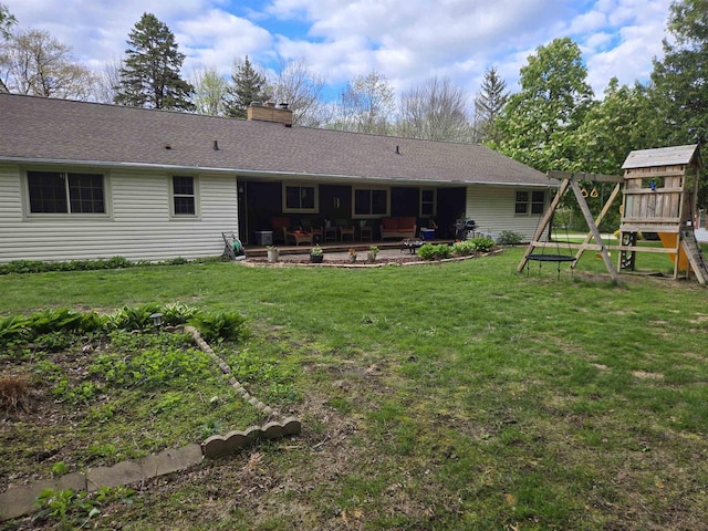 4817 Morgan Dr, Manitowoc, WI 54220 - rear view of house with a playground, a patio area, a chimney, and a lawn
