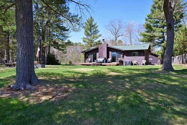 10151 N Sandy Beach Rd, Hayward, WI 54843 - view of grassy yard featuring a wooden deck