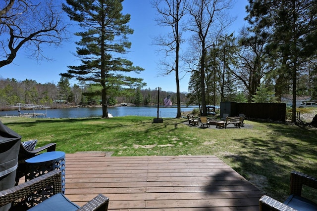 10151 N Sandy Beach Rd, Hayward, WI 54843 - wooden deck with a water view, a lawn, and an outdoor fire pit