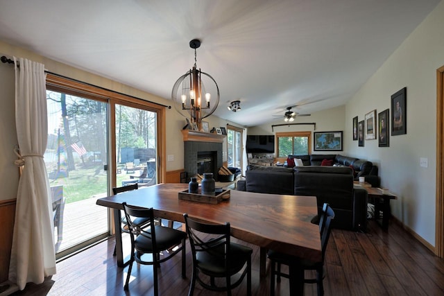 10151 N Sandy Beach Rd, Hayward, WI 54843 - dining area with dark wood-style floors, a glass covered fireplace, a chandelier, and ceiling fan