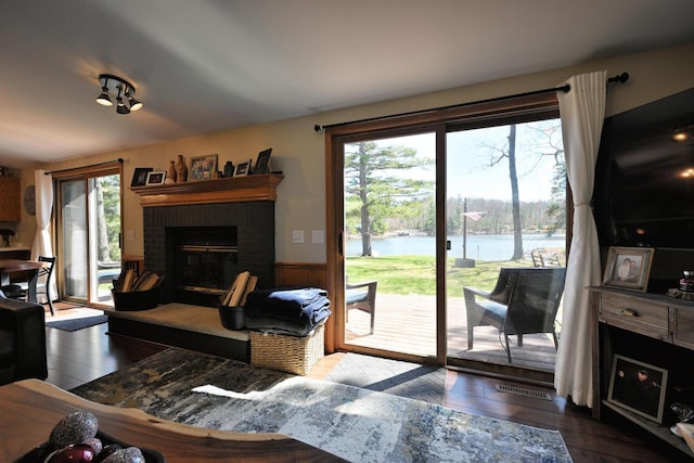 10151 N Sandy Beach Rd, Hayward, WI 54843 - living room with healthy amount of natural light, wood finished floors, a fireplace, and a wainscoted wall