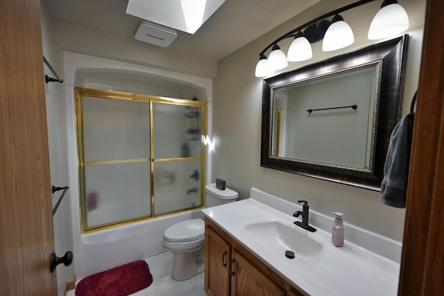 10151 N Sandy Beach Rd, Hayward, WI 54843 - bathroom featuring toilet, vanity, bath / shower combo with glass door, and a skylight