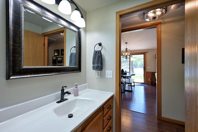 10151 N Sandy Beach Rd, Hayward, WI 54843 - bathroom featuring wood finished floors, vanity, and a chandelier