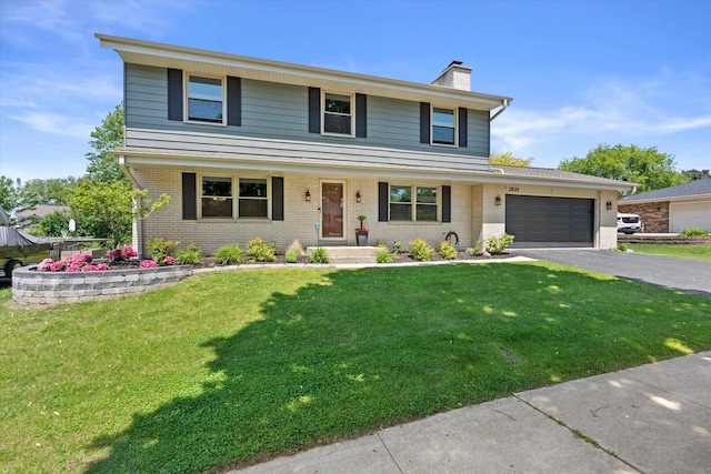 2824 Minot Ln, Waukesha, WI 53188 - view of front of house featuring asphalt driveway, a chimney, brick siding, and an attached garage