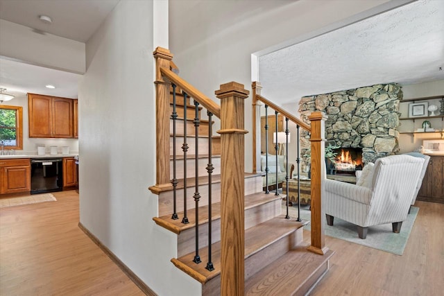 2824 Minot Ln, Waukesha, WI 53188 - stairs featuring wood finished floors, a fireplace, and baseboards