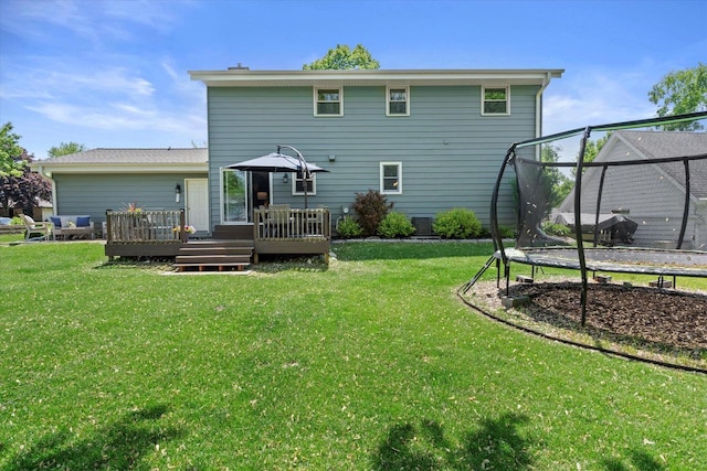 2824 Minot Ln, Waukesha, WI 53188 - back of house with a trampoline, a deck, a yard, and central AC