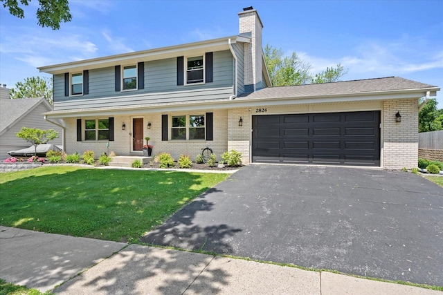 2824 Minot Ln, Waukesha, WI 53188 - view of front of property featuring brick siding, asphalt driveway, an attached garage, a chimney, and a front lawn
