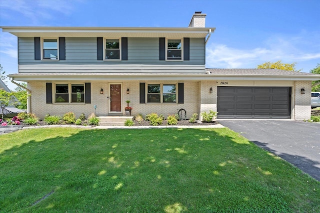 2824 Minot Ln, Waukesha, WI 53188 - view of front of property with a chimney, brick siding, asphalt driveway, and an attached garage