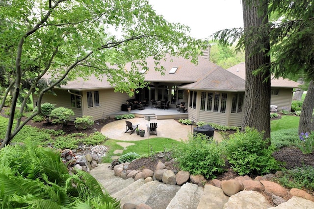 9111 400th Ct, Genoa City, WI 53128 - back of house featuring a patio area, a shingled roof, and a chimney