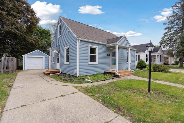 947 Cleveland St, Beloit, WI 53511 - bungalow-style home featuring an outdoor structure, a shingled roof, a garage, and driveway